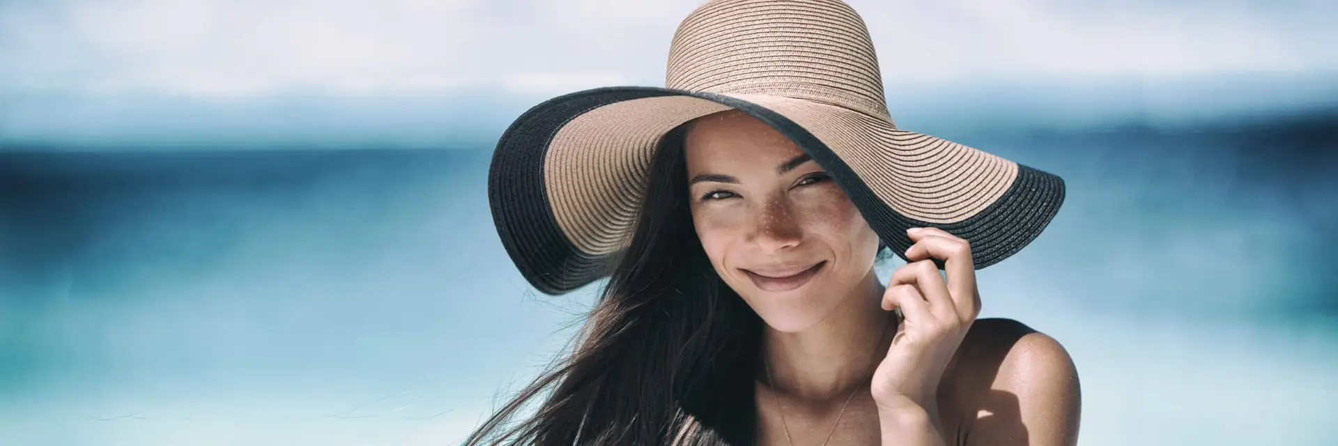 Woman wearing a sun hat to protect against sun damage
