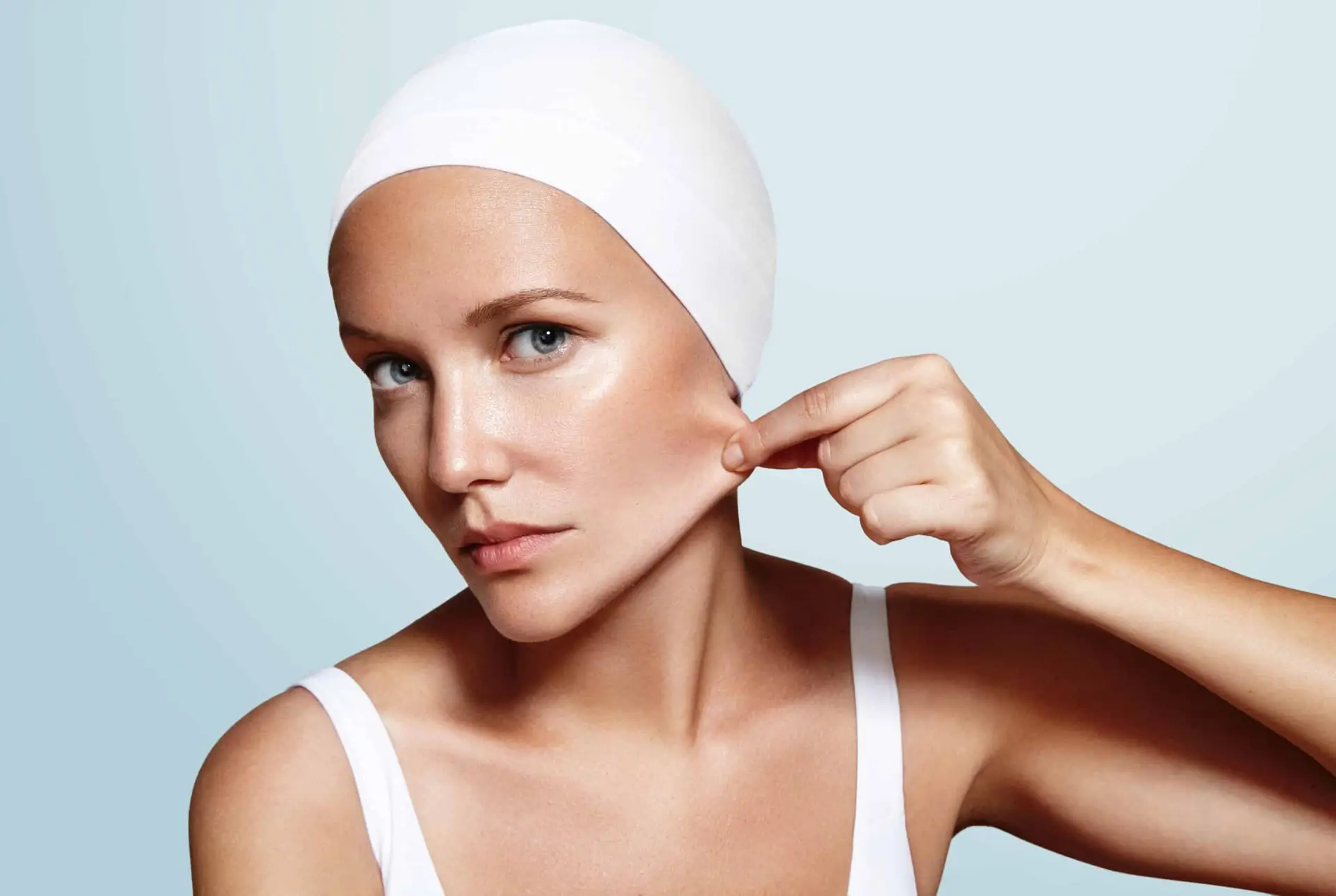 Woman demonstrating skin laxity and elasticity on cheek